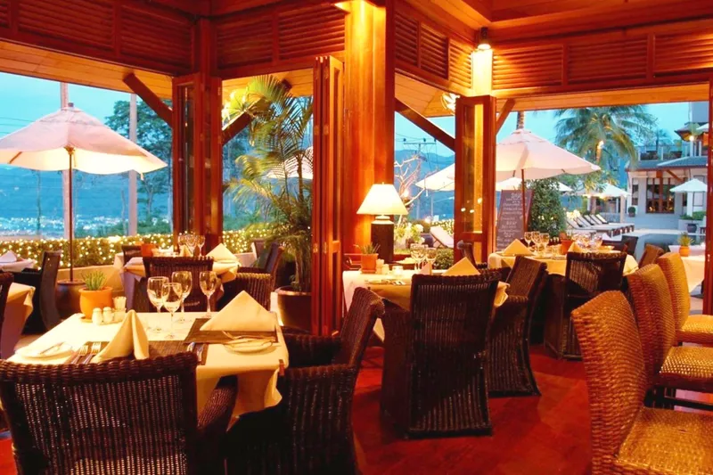 Inside RICE: tables laid in white by the open windows, the bay beyond