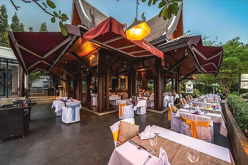 The RICE sala by day, tables dressed in white with saffron sashes